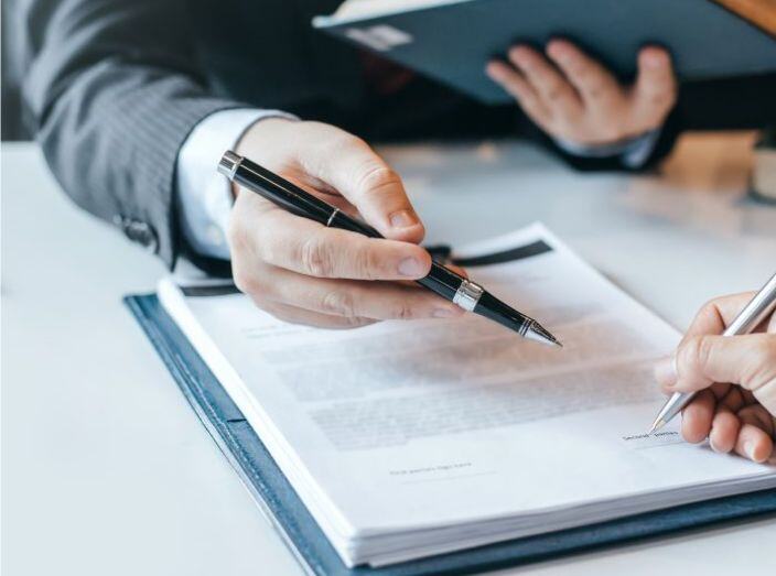 Person signing a legal looking document.